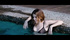 Tall Caucasian babe takes off her clothes and kisses guy while swimming.