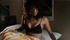 Tall woman prepares her things before going to bed in lingerie.