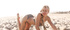 Cute blonde teen enjoys stretching her legs on the beach