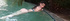 busty brunette swimming and