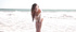 Tight brunette in white leotard enjoys sunny day on a beach