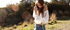 Petite long-haired brunette wears no bra under her white sheer shirt
