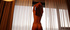 Hot blonde tattooed chick enjoys teasing and posing behind the curtain