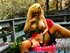 MILF with huge tits smokes a brown cig on her deck, taking drags with her pussy.