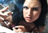 A modest chub is sucked on by a brunette who is smoking hot and smoking a cig.