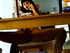 Tantalizing dame seated at a desk rubs her pussy while chatting on the telephone.