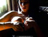 Mysterious brunette is framed by sunlight while puffing on a tasty cig.