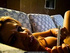 Sexy siren sucks her cigarette while lounging on her patterned couch.