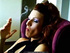 Pretty MILF in sheer nylons inhales deeply while smoking her cigarette indoors.