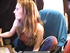 Long-haired brunette in a red vest smoking while chatting on-line