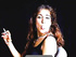 French brunette MILF in a top looks sexy while smoking