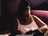 Big-boobed ebony fatty in a white top enjoys smoking