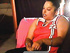 Plump ebony bitch in a red vest chatting on mobile and smoking