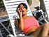 Swarthy ponytailed latina with big funbags smoking on the chaise longue and in the pool