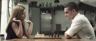 brunette plays chess with